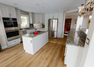 STONE OAK KITCHEN REMODEL - Quartzite countertops, Island cooktop with double ovens. Stainless steel tile backsplash