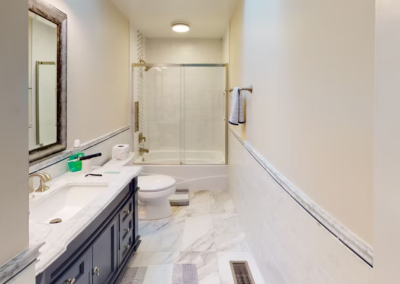 BATHROOM REMODEL - Small full bath with tile shower surround, tile floor and tile wainscot.