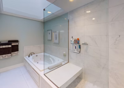 LONG BATHROOM REMODEL - Long bathroom remodel with tiled walk-in shower, tiled bench, glass surround, jetted tub and tile flooring